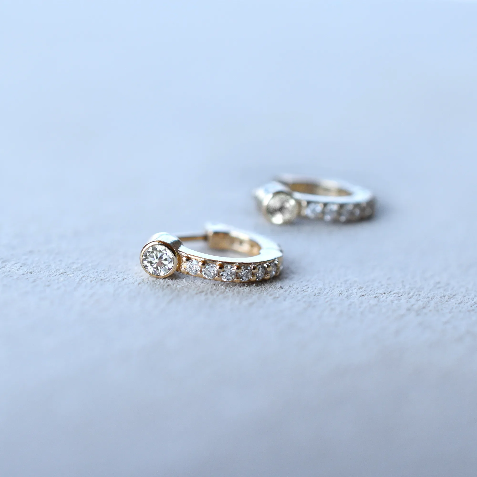 Tiny Birthstone Huggie Hoops with Diamonds in 14k Gold - Image 6